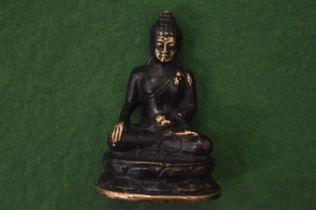 A small bronze Buddha.