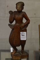 An Eastern carved wood figure.