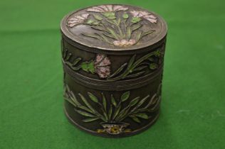 A French white metal and enamel decorated circular pot and cover.