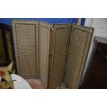 A brass close-nailed and upholstered four panel folding dressing screen.