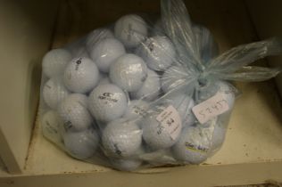 A bag of fifty Top Flite golf balls.