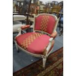 Decoratively upholstered and painted low armchair.