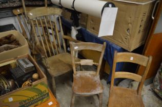 Five various beech and elm kitchen chairs, two with arms.