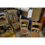 Five various beech and elm kitchen chairs, two with arms.