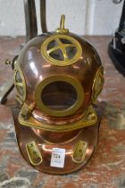 A miniature copper and brass divers helmet.
