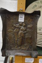 An embossed brass dish decorated with young lovers.