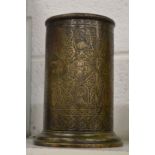 An Islamic engraved brass cylindrical vessel.