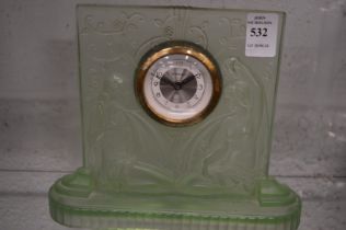 An Art Deco green glass mantle clock in the manner of Lalique.