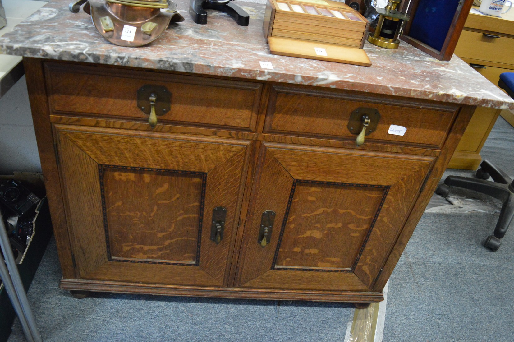 A Warings oak cabinet with two drawers and two panelled cupboard doors with replacement marble top.