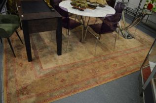 A Persian style machine made carpet, beige ground with floral decoration 360cm x 275cm.