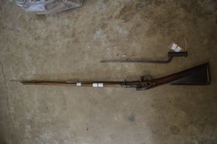 The stock for a Brown Bess rifle, circa 1800 together with a Brown Bess bayonet.