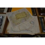 A folder of unframed maps.