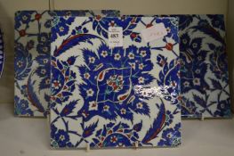 A set of three Iznik style floral decorated pottery tiles.