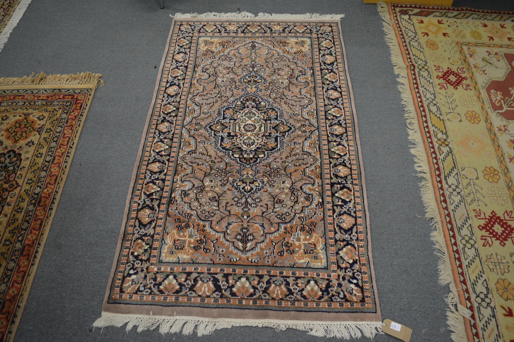 A small Persian style rug, grey ground with floral decoration 160cm x 90cm.