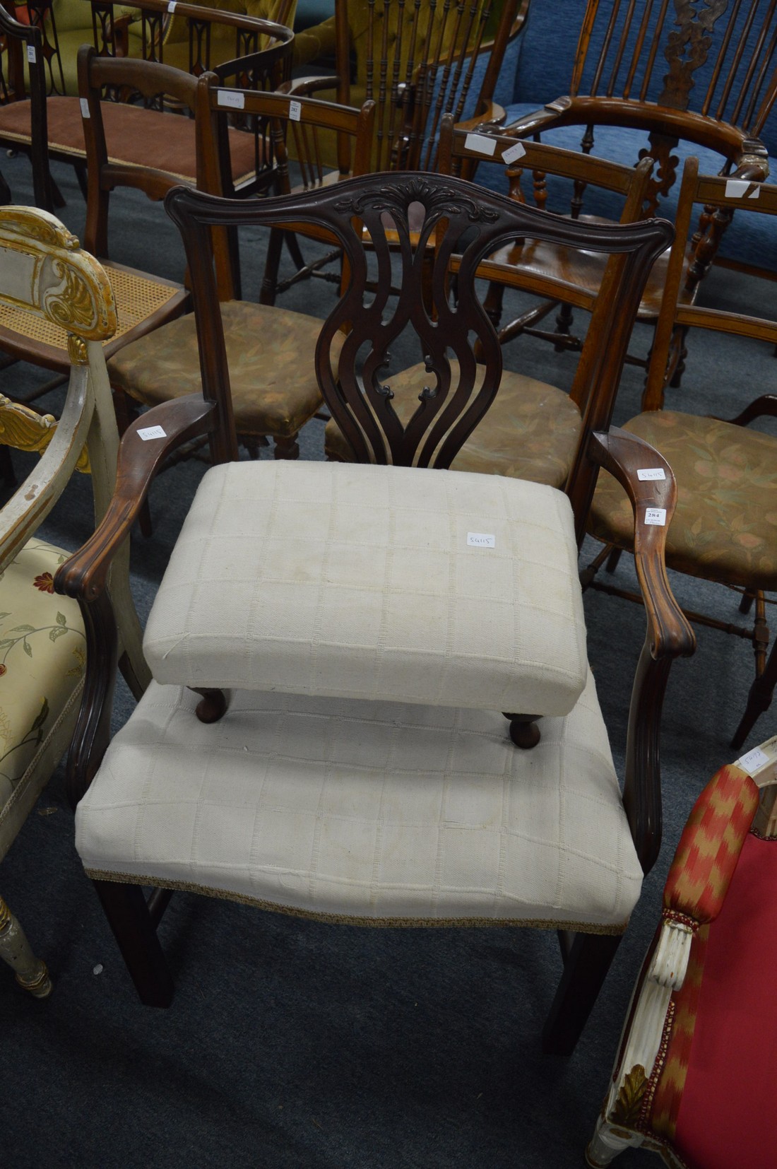 Chippendale style mahogany chair with arms together with a similarly upholstered stool.