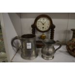 Two pewter tankards and a small mantle clock.