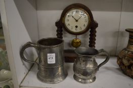 Two pewter tankards and a small mantle clock.