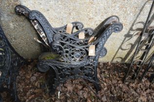 Two pairs of cast iron bench ends.