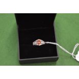 An 18ct white gold, diamond and orange sapphire ring, size N.