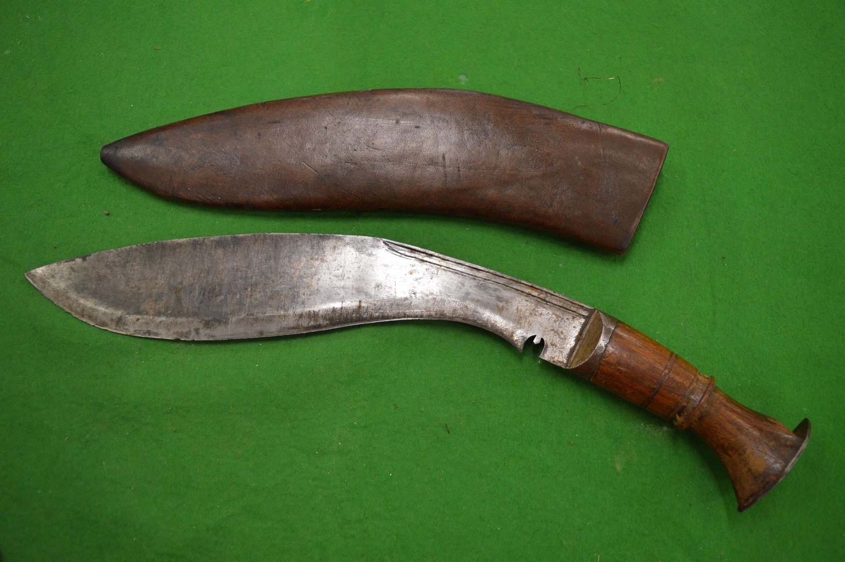 A Gurkha kukri with leather scabbard.