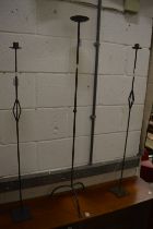 Three wrought iron candle stands.