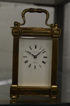 An Asprey brass carriage clock.