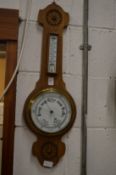 Oak cased barometer/thermometer.
