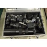 Aluminium camera case containing three Canon camera bodies and numerous lenses.