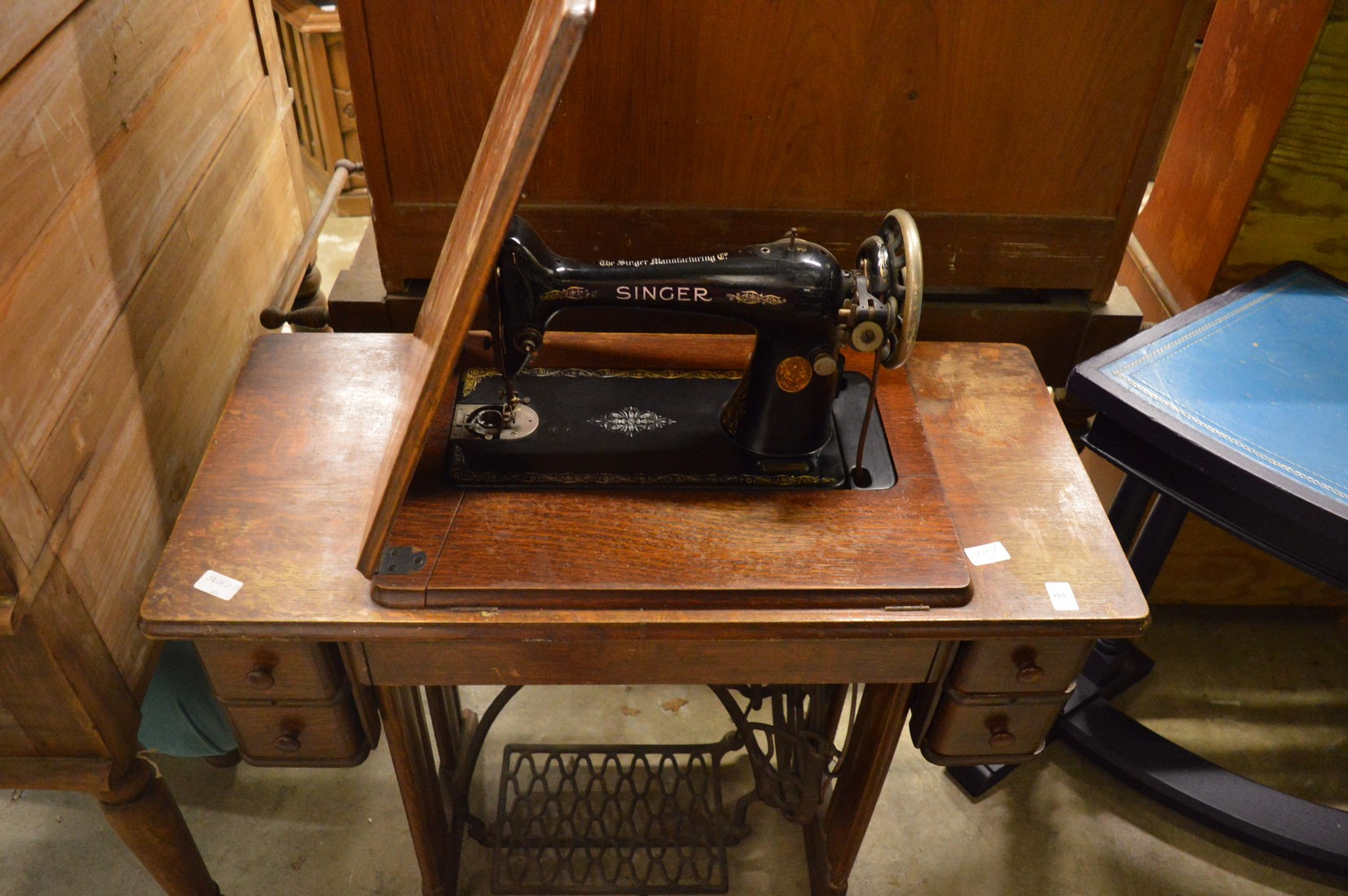 A Singer treadle operated sewing machine.