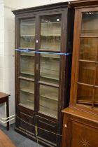 A large grained pine four door bookcase.