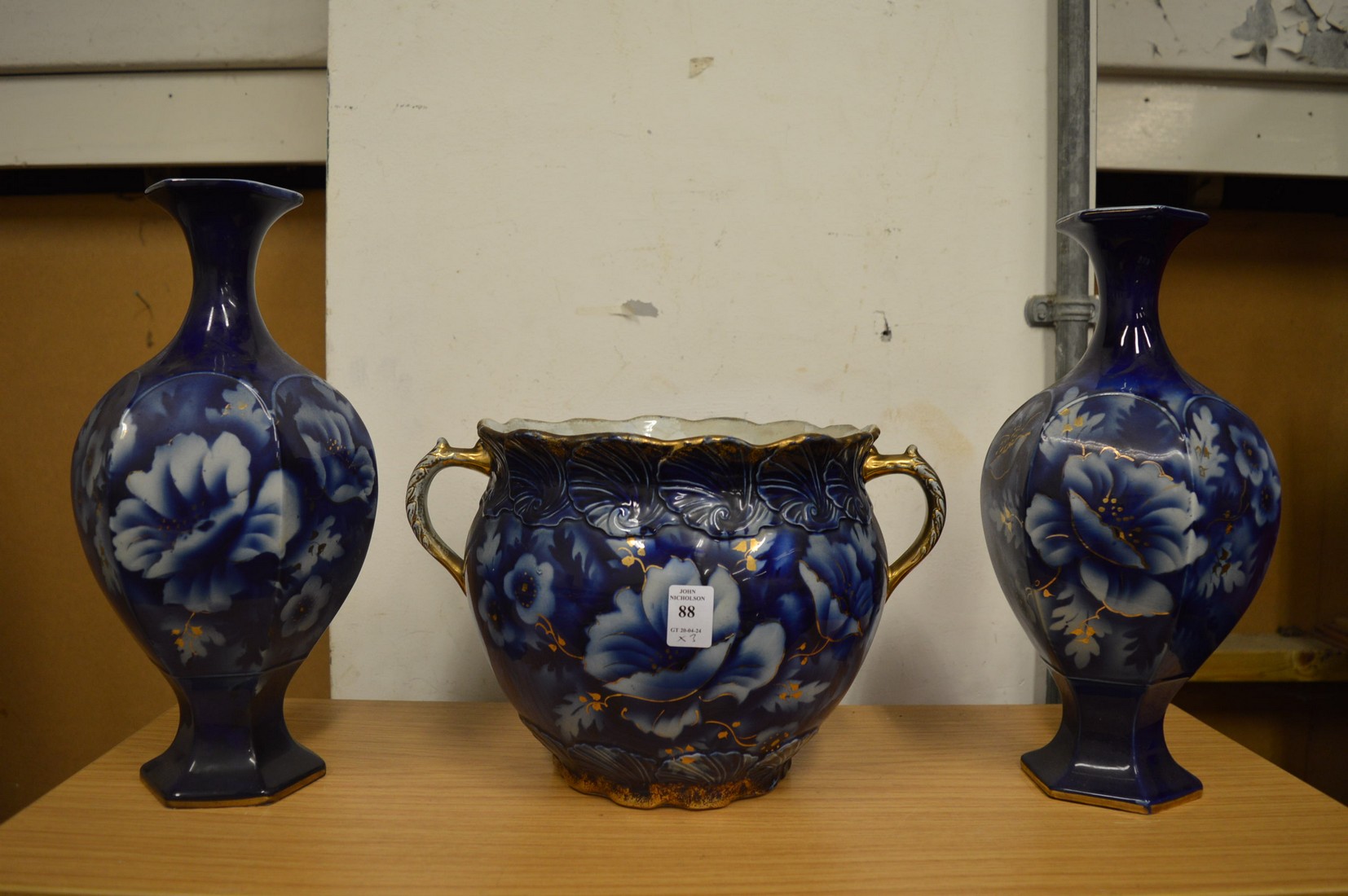 A twin handled jardiniere and pair of matching vases.