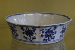 A Chinese blue and white dish with shaped rim.