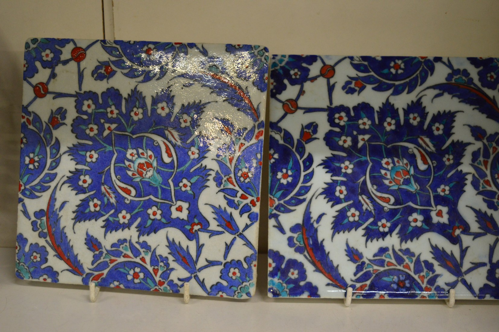 A set of three Iznik style floral decorated pottery tiles. - Image 2 of 3