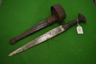 An African arm dagger with embossed leather handle, mounts and sheath.