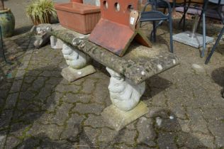 A reconstituted stone garden bench with squirrel supports (repaired).