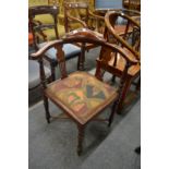 An Edwardian inlaid mahogany corner armchair.