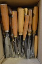 A collection of old wood carving chisels.