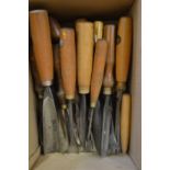 A collection of old wood carving chisels.