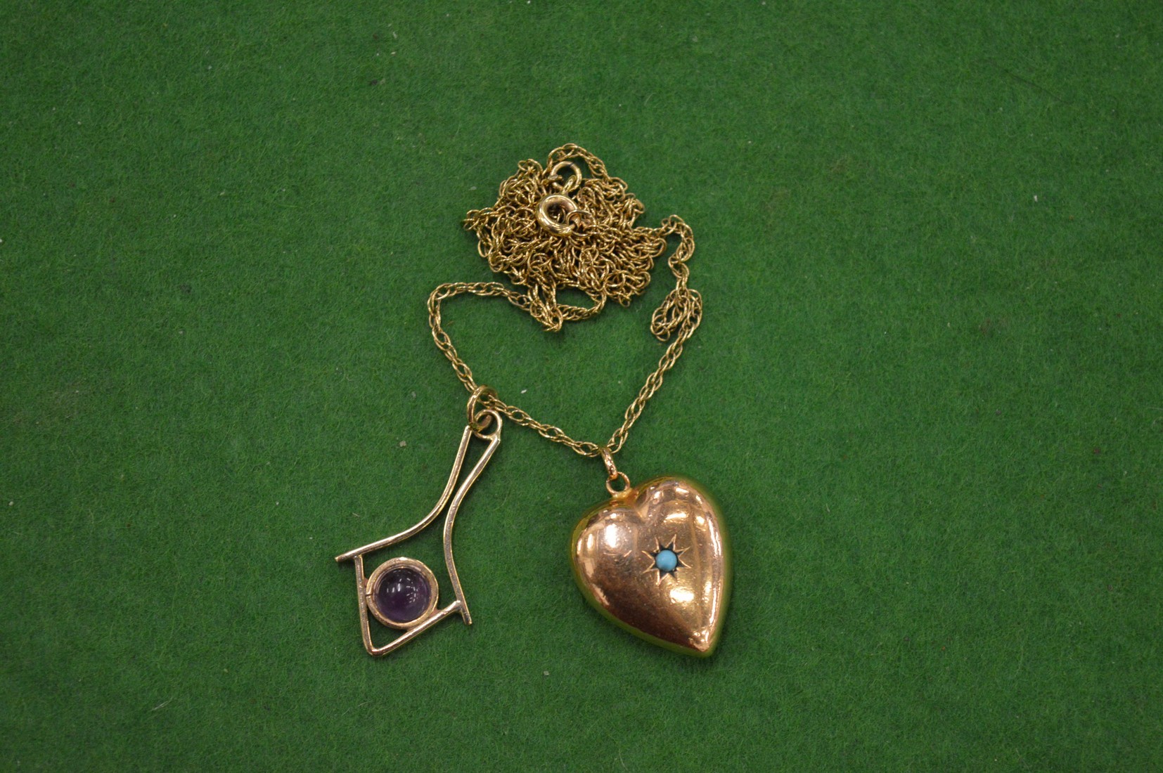 A 9ct gold heart shaped locket inset with a turquoise cabochon stone together with a 9ct gold