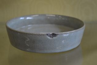 A Chinese celadon glazed circular dish.