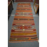 A Kilim runner 297cm x 95cm.