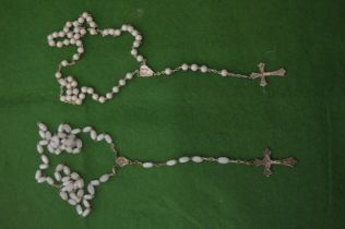 Two rosary necklaces with pearls and white beads.