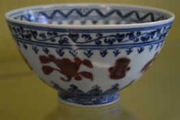 A Chinese blue, white and red decorated circular bowl.