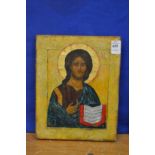 A 19th century Russian icon, the figure holding a book.