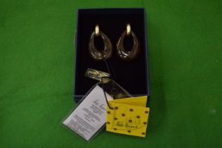 A pair of designer earrings.