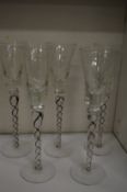 A set of five stylish cordial glasses with air twist stems.