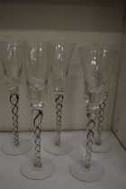 A set of five stylish cordial glasses with air twist stems.