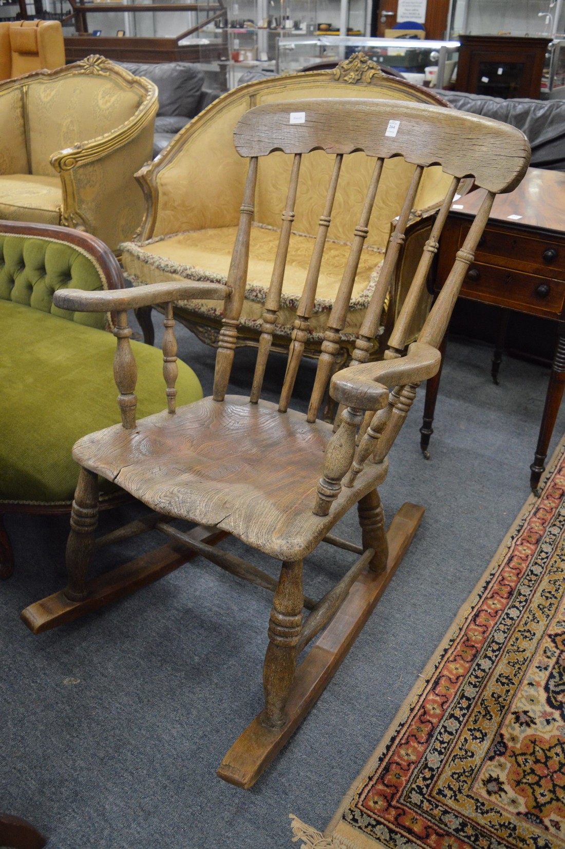 A Victorian beech framed spindle back rocking chair.