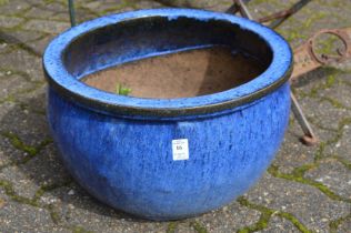 A pair of turquoise glazed planters.