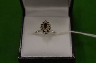 An 18ct white gold, diamond and ruby cluster ring, size O.